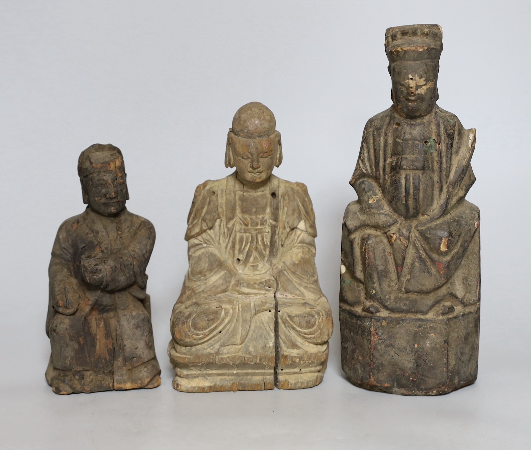 Three Chinese carved wooden figures seated immortals, Qing dynasty, Tallest 26cm
